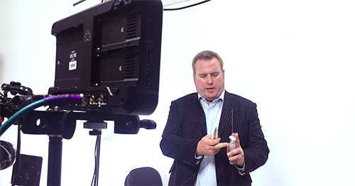 manexplaining his product infront of a video camera