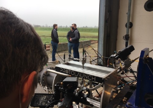 Man filming three people talking